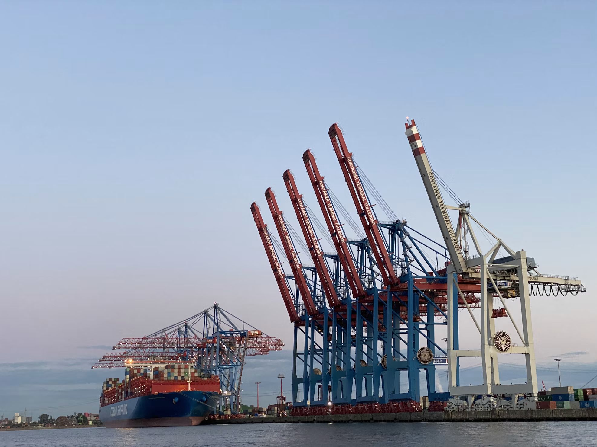 Ship-to-shore cranes at a container terminal at dusk